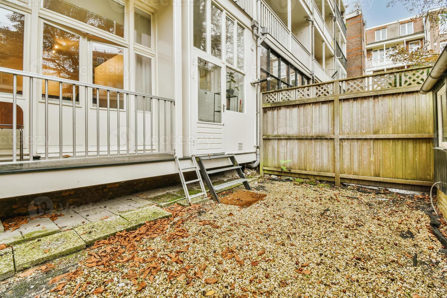 A small yard with a fence and a gate photo