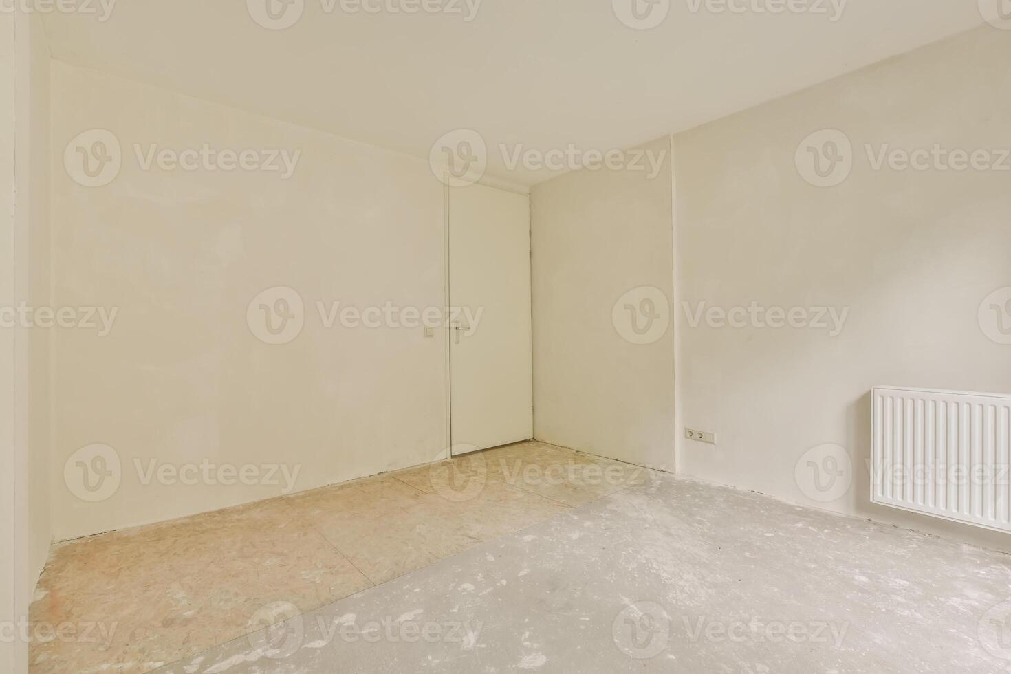 An empty room with a radiator and a door photo