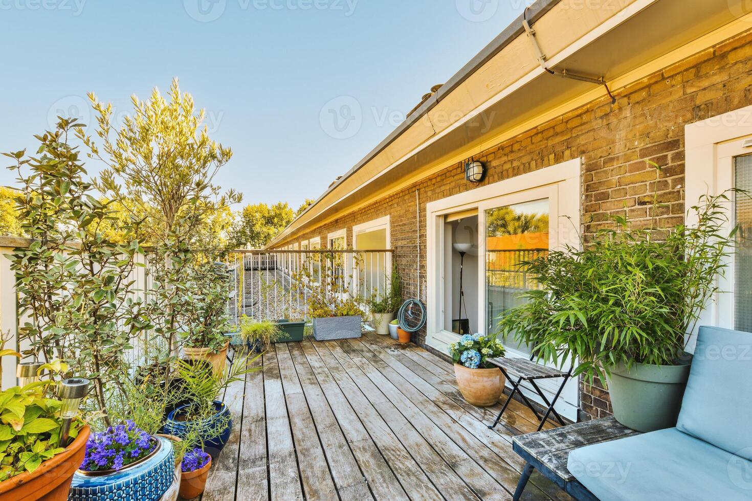 A wooden deck with a blue chair photo