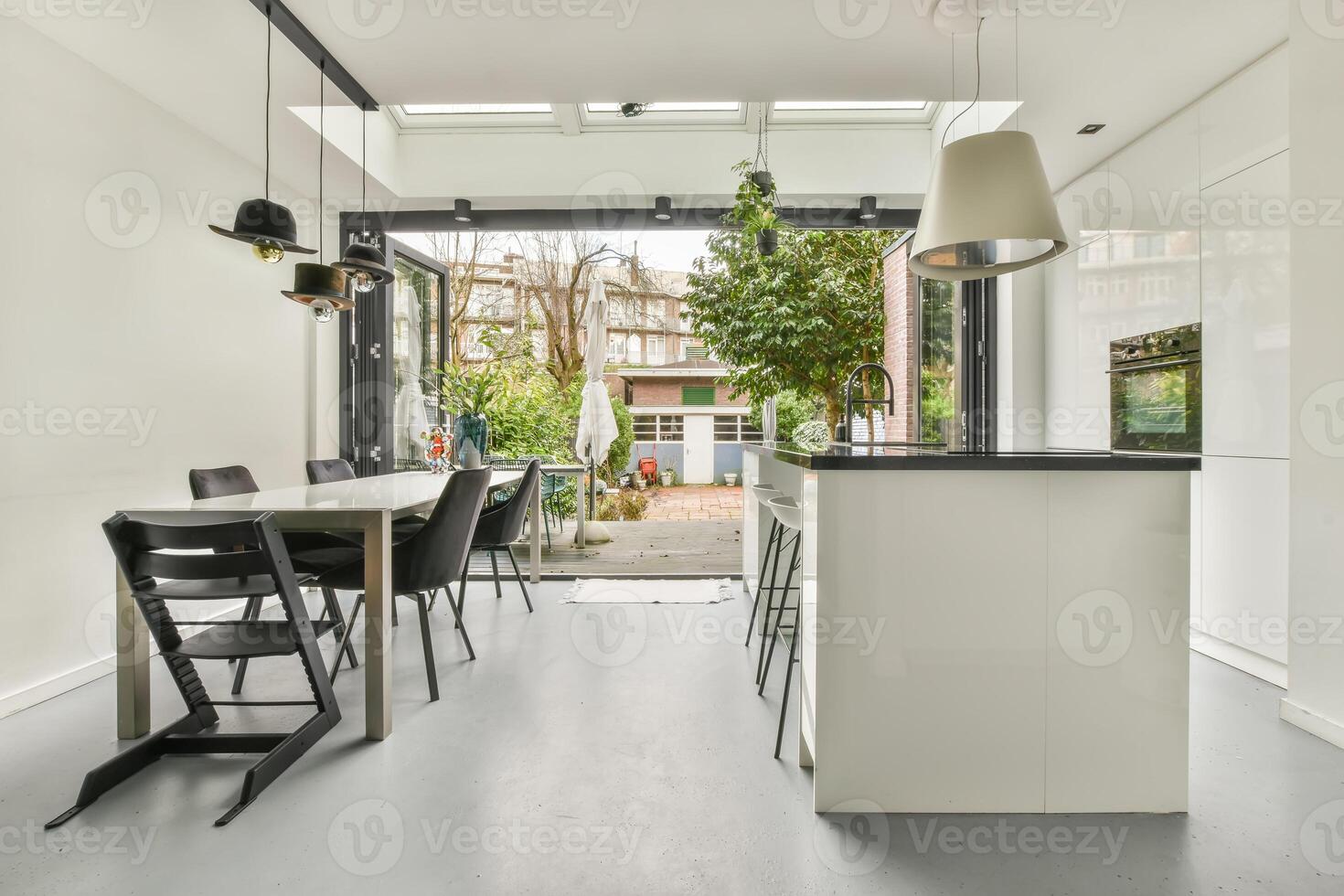 A kitchen with a dining table and chairs photo