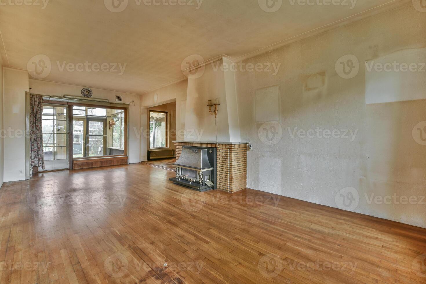 A room with a fireplace and wooden floors photo