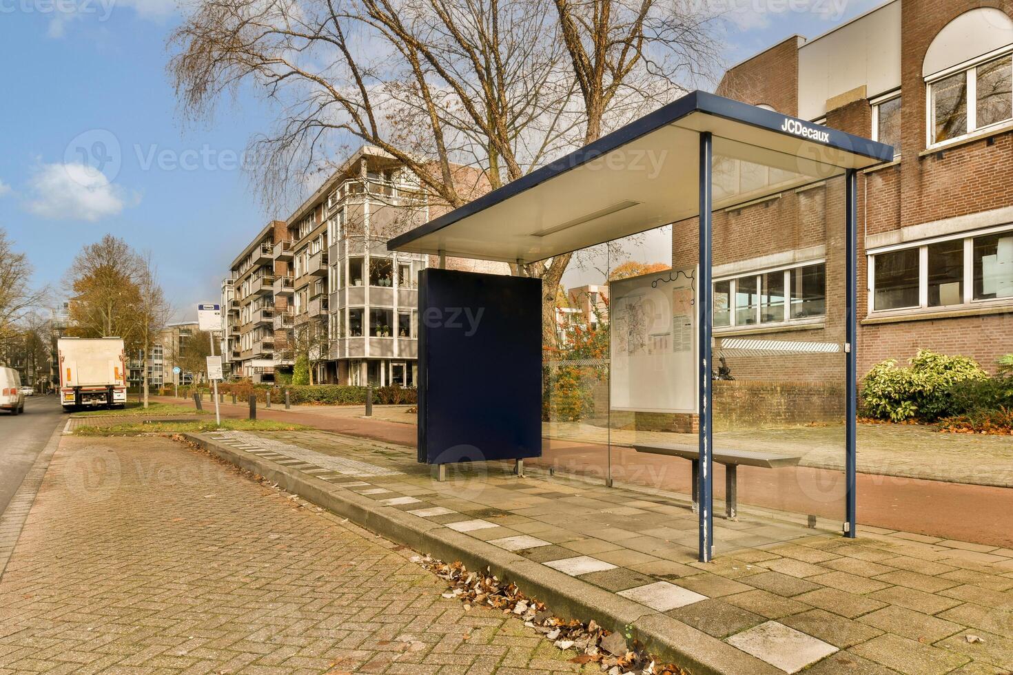 A bus stop with a bench photo