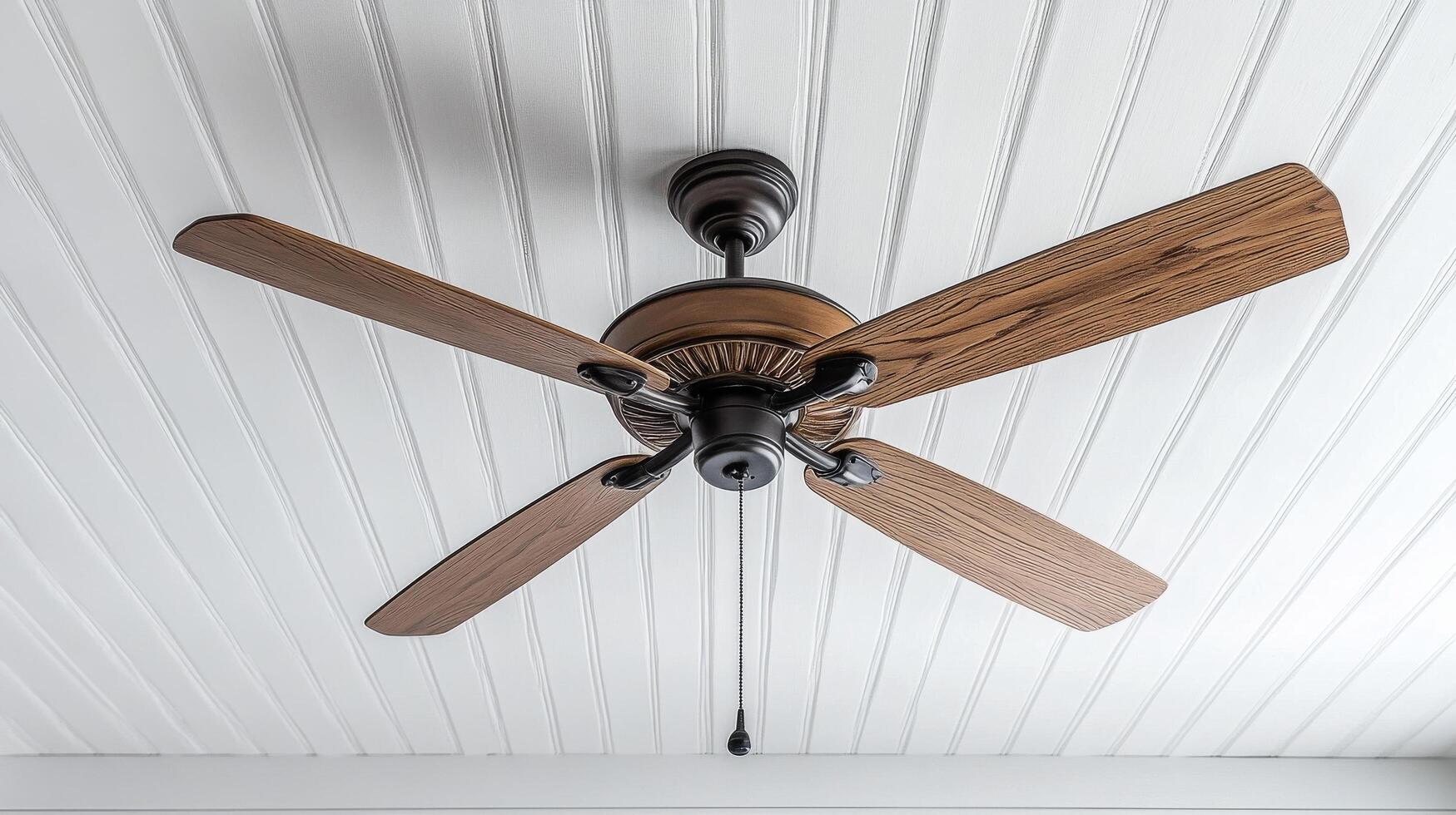 Ceiling fan with wooden blades in a bright, airy room with large windows and white walls photo
