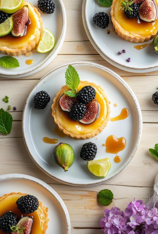 Delicious fruit tart with figs, blackberries, and lime on a wooden table photo