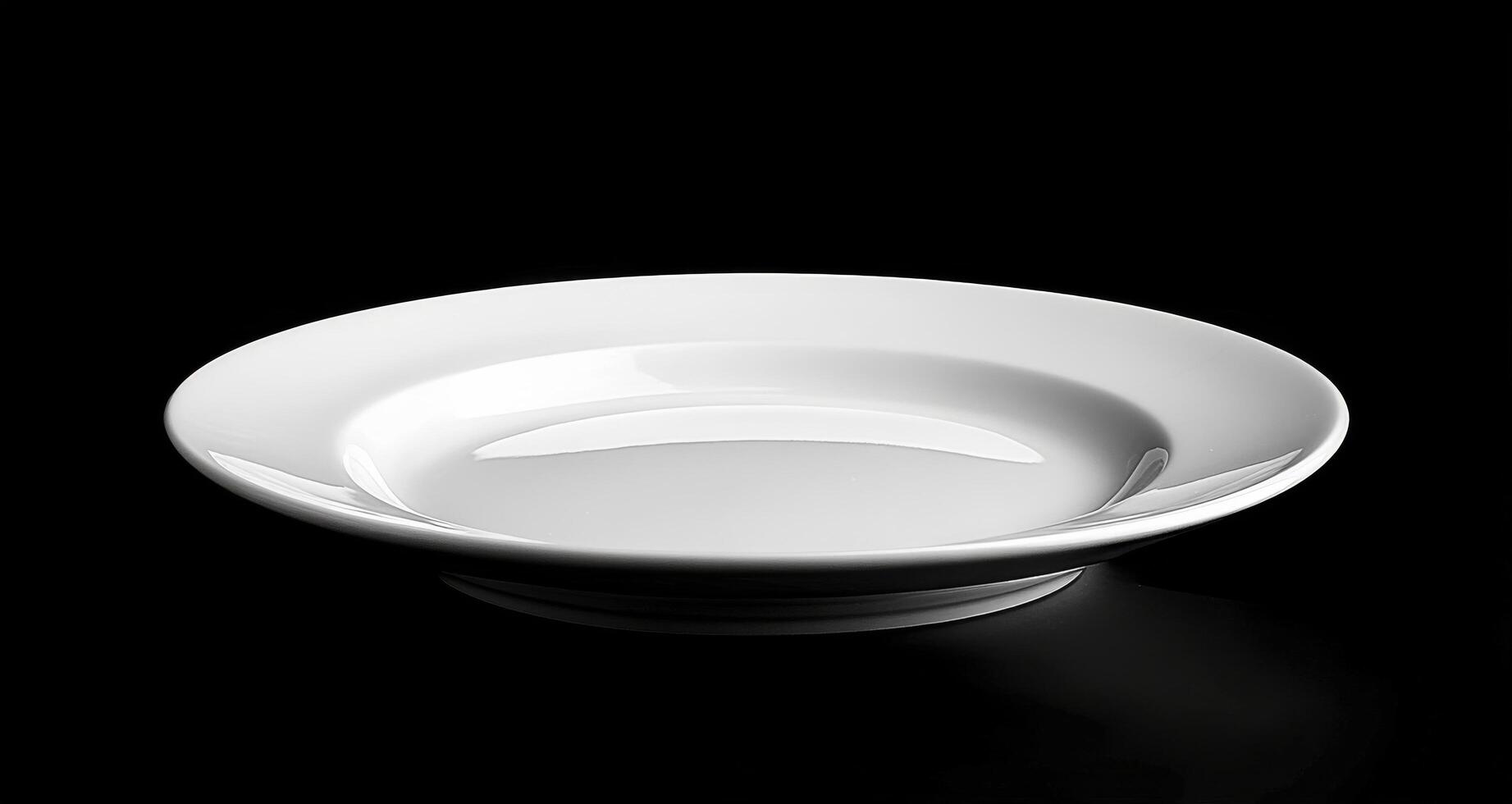 Simple white ceramic plate on a dark background showcasing elegant design and form photo
