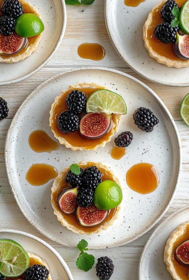 Delicious fruit tart with figs, blackberries, and lime on a wooden table photo
