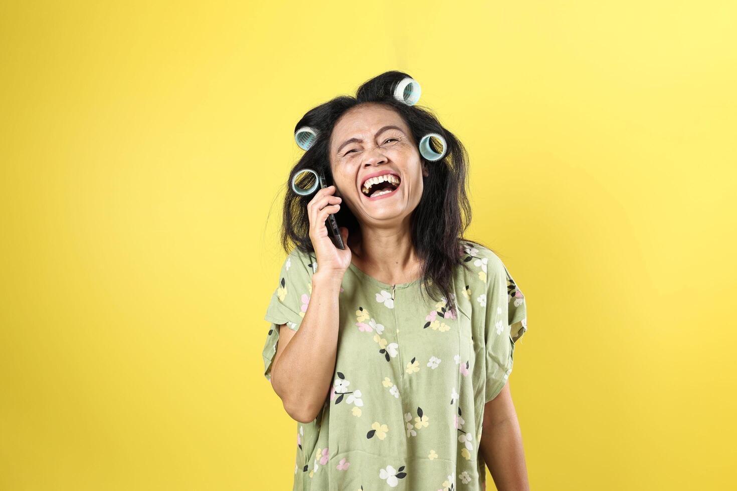 Indonesian Mom Laughing While Making a Call photo