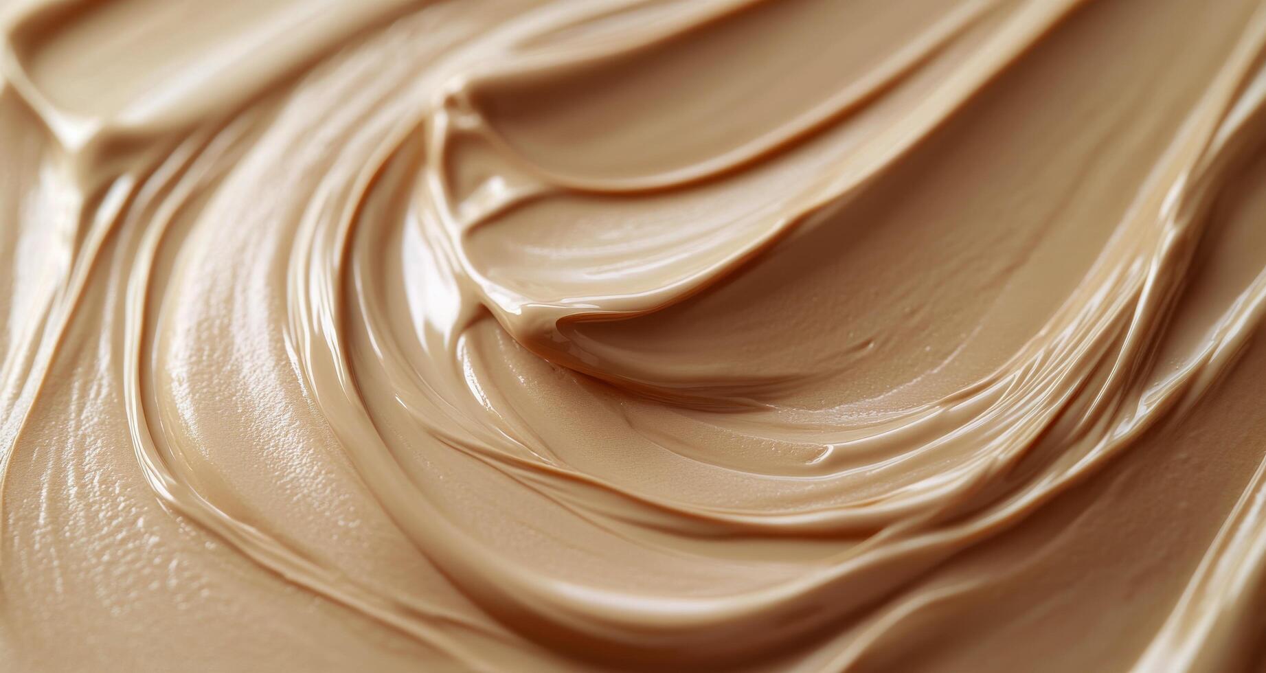 Creamy beige texture swirls in a close-up view showcasing smoothness and richness photo