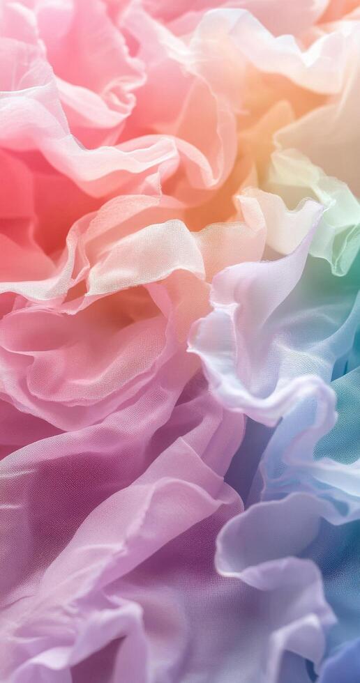 Colorful ruffled fabric in soft pastels creating a dreamy texture in warm light photo