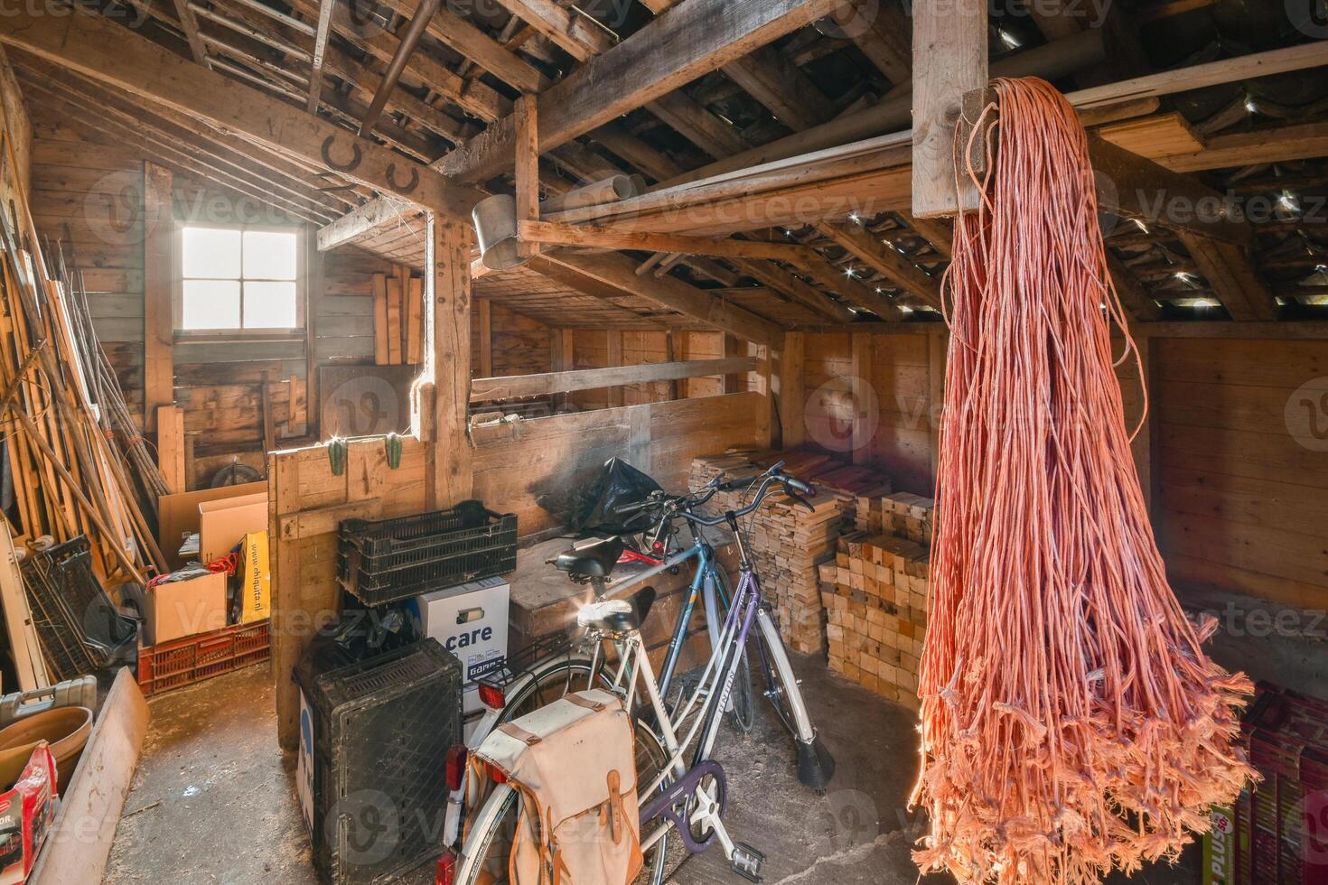 An attic with a bike and a bunch of tools photo