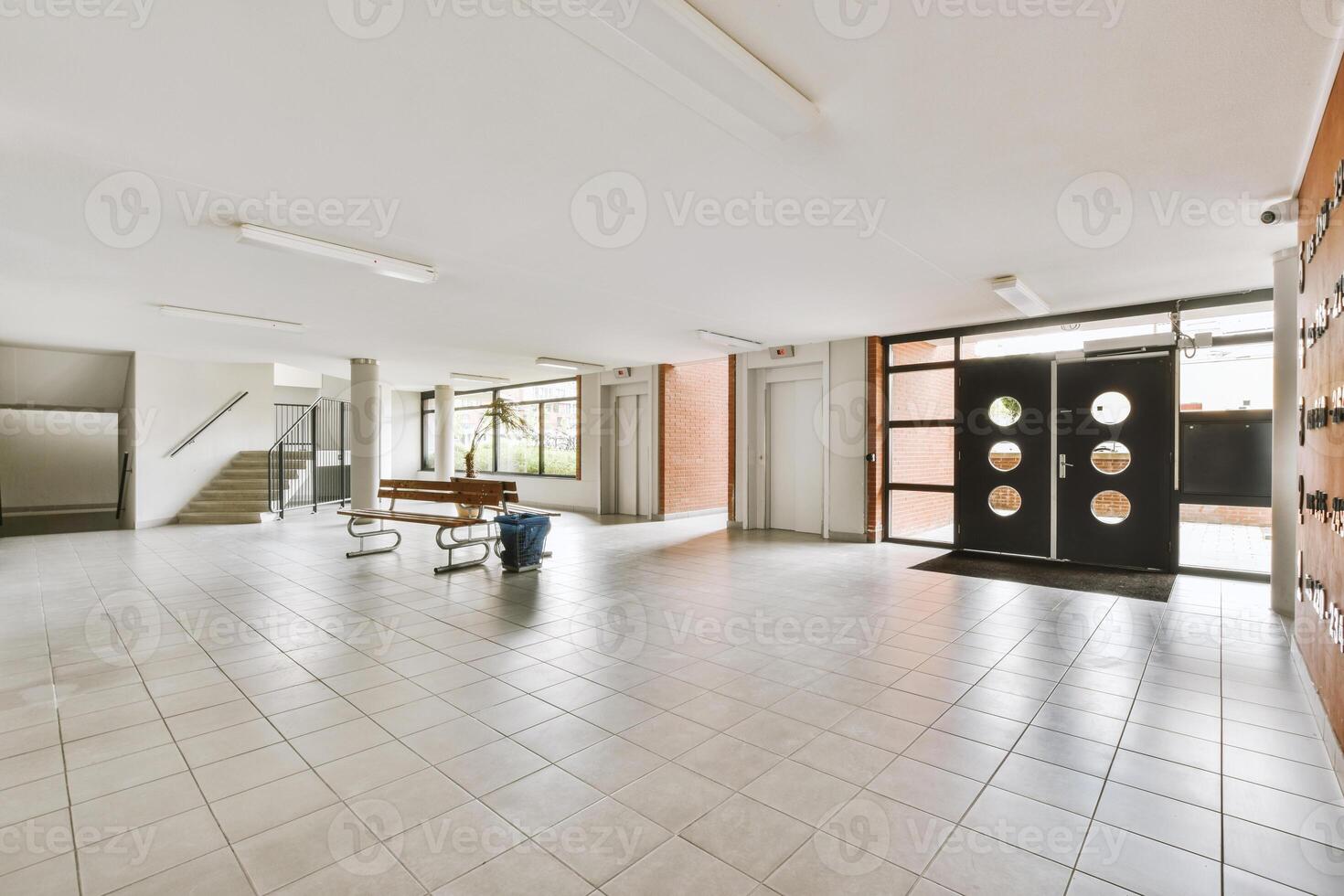 A large empty hallway with a large door photo