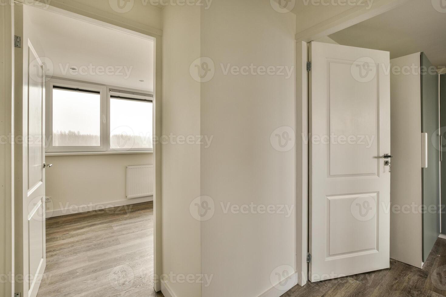 Empty room with white doors and wooden floor photo