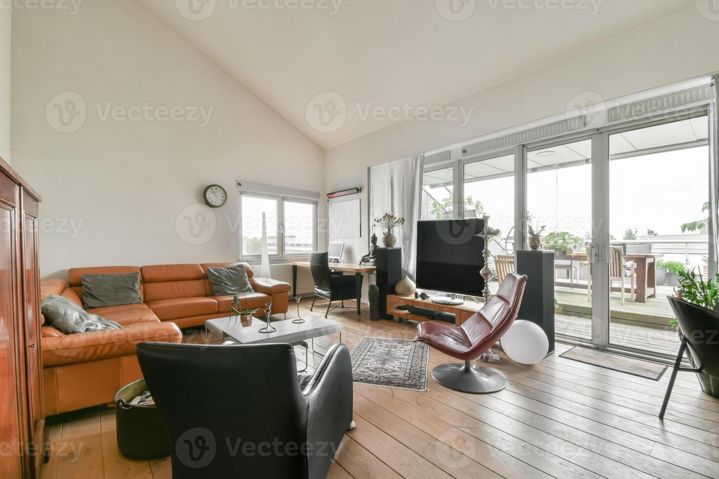 A living room with a large window and wooden floors photo