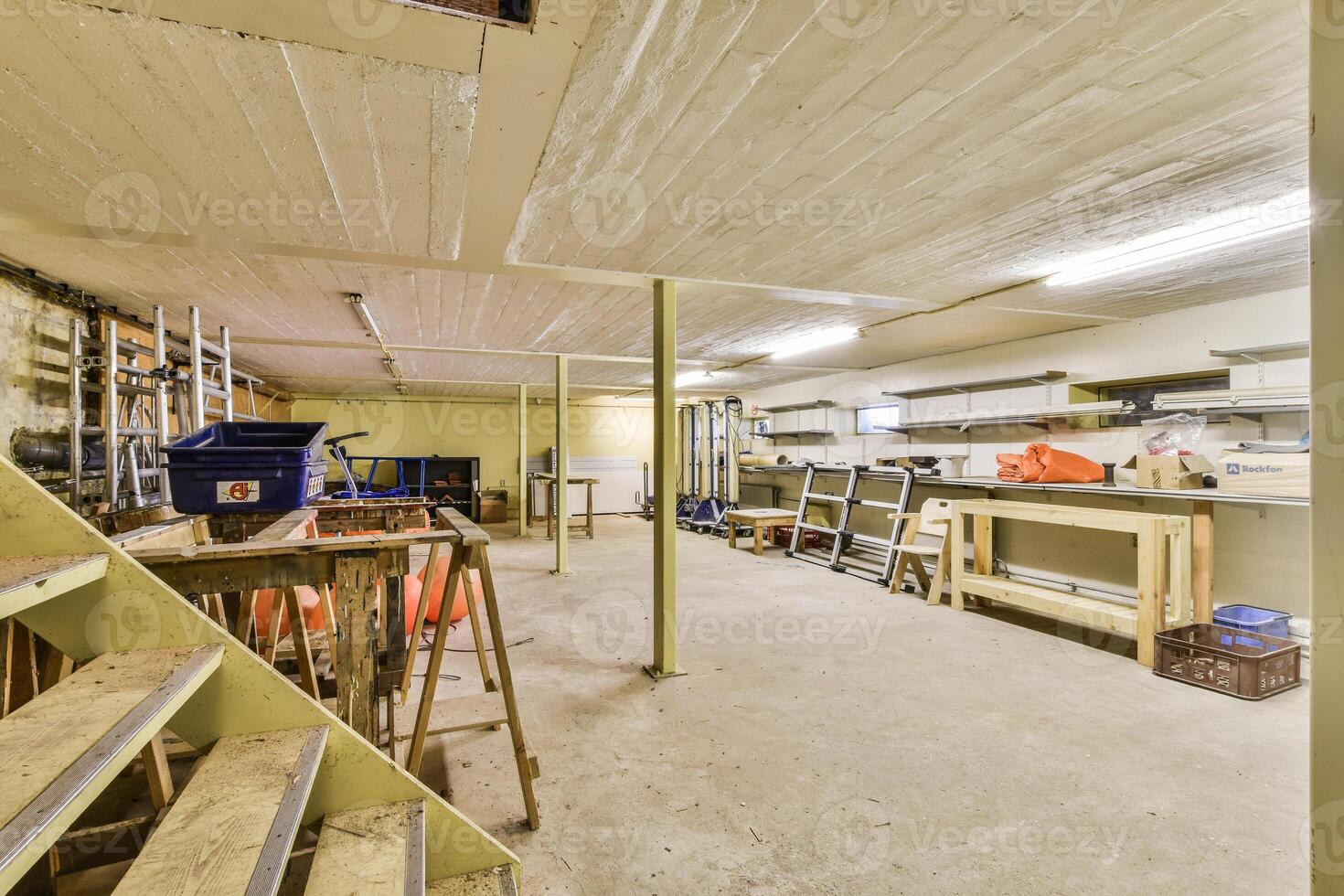 A room with a ladder and a bunch of tools photo