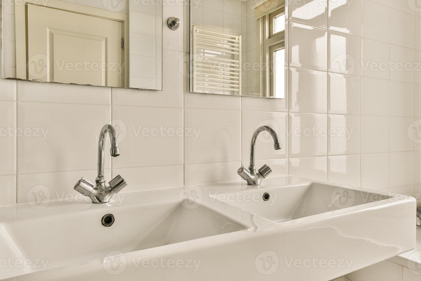 A bathroom with two sinks and a mirror photo