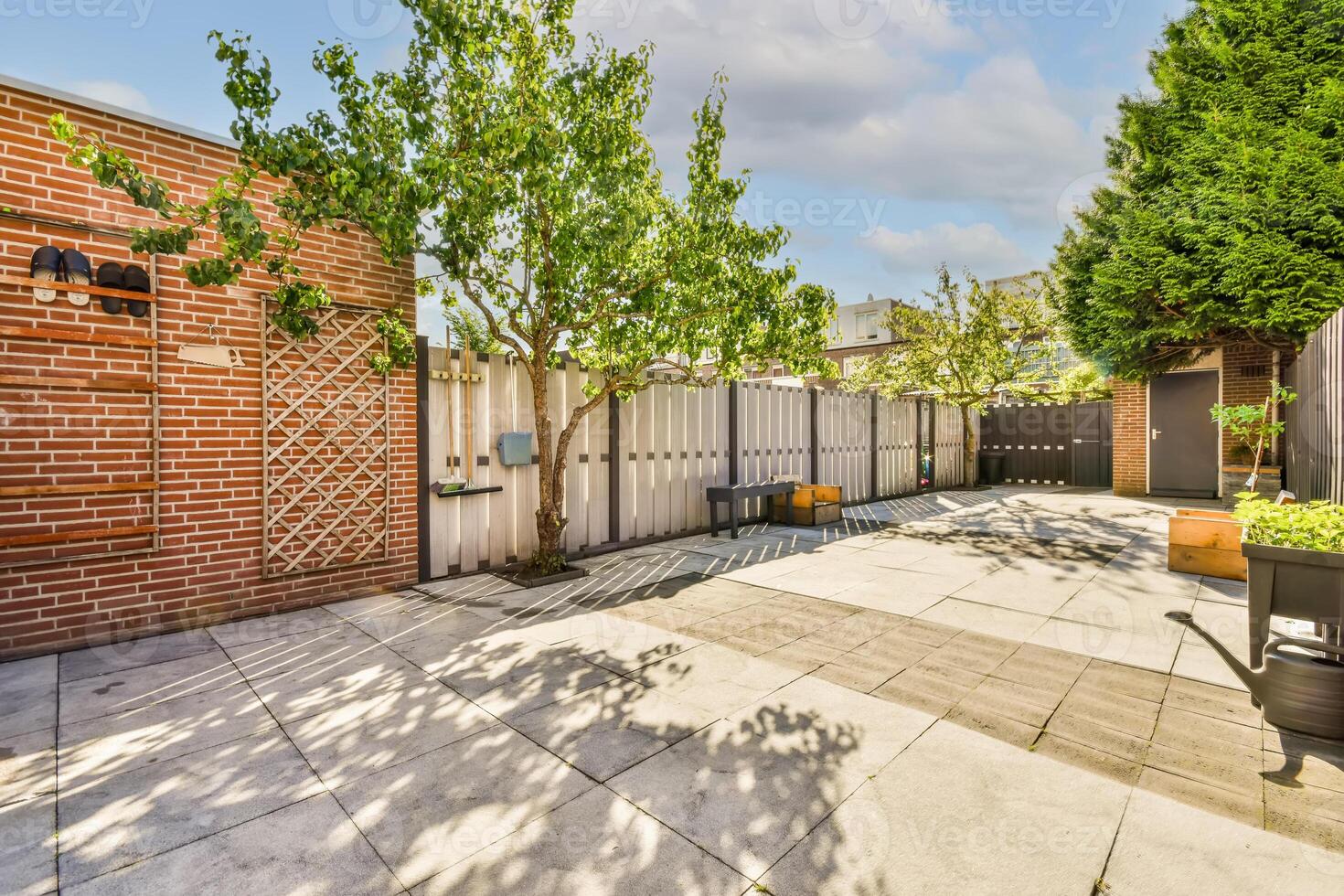 A backyard with brick walls and a patio photo