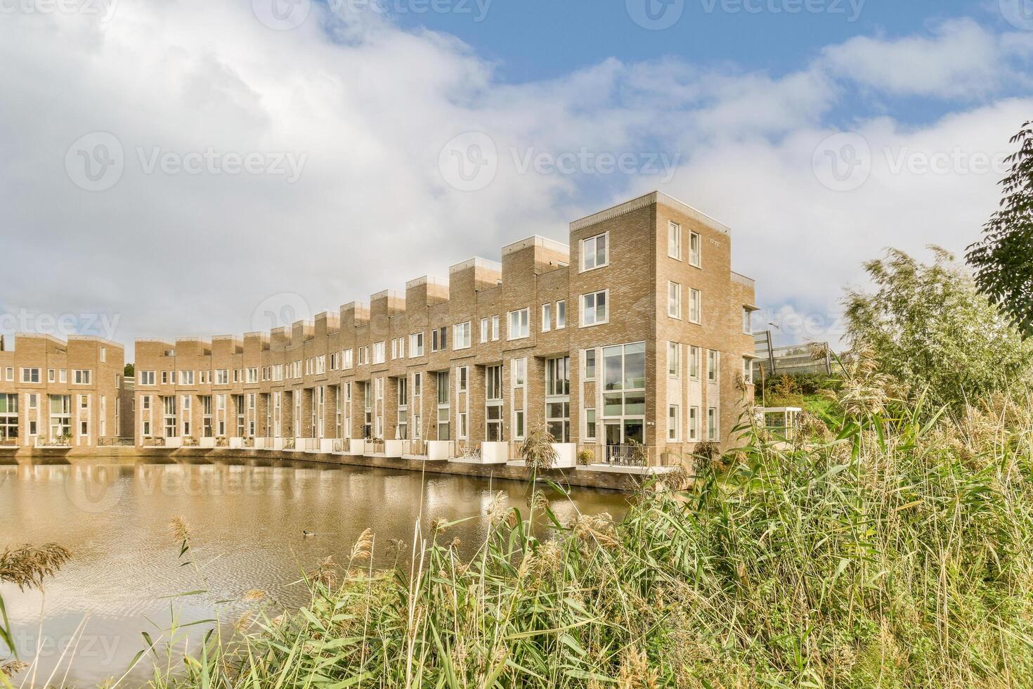 A building with a pond in front of it photo
