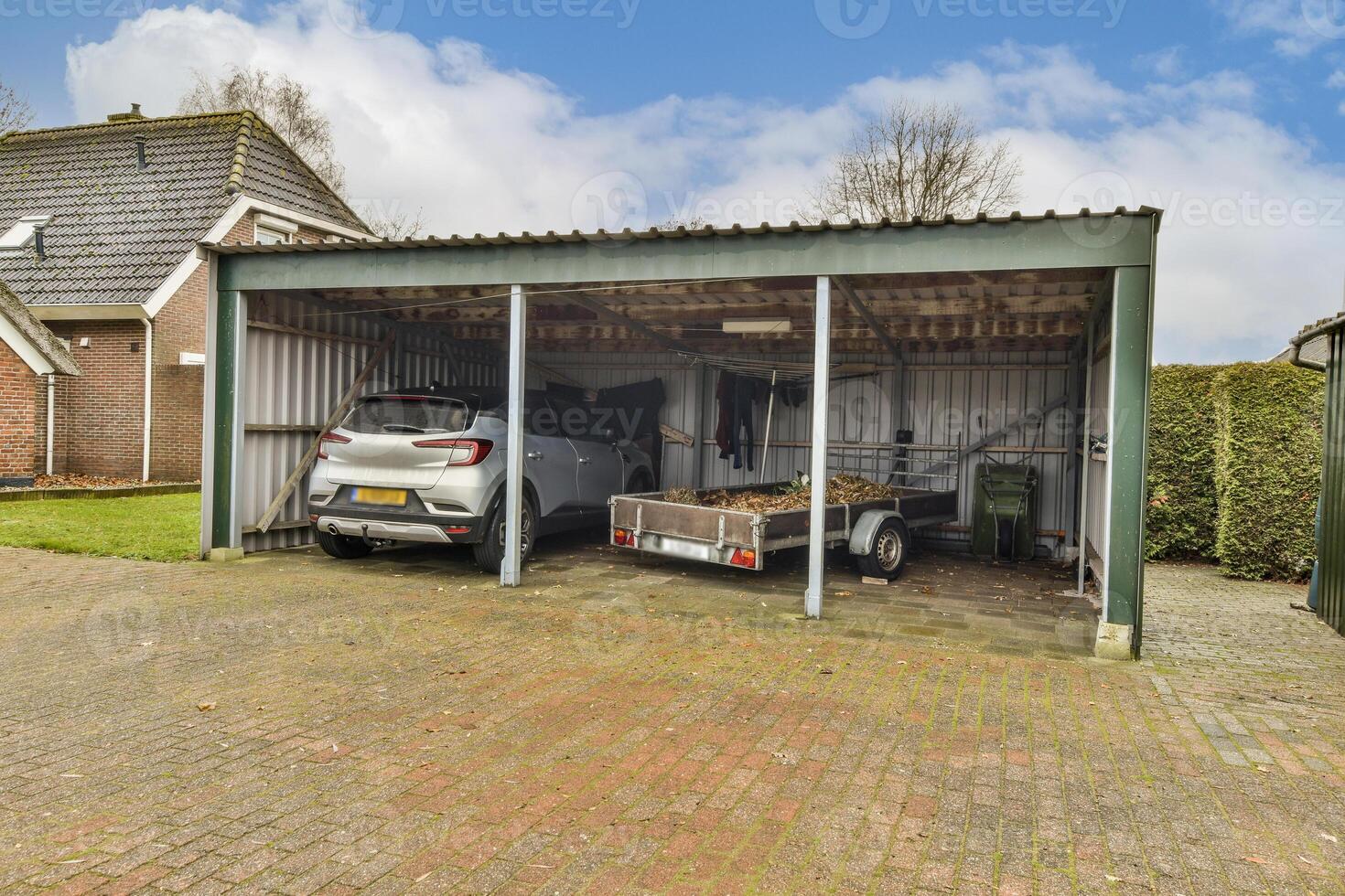 A garage with two cars parked inside photo