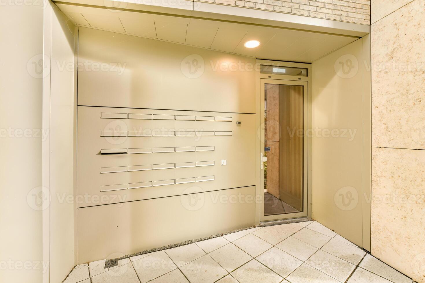 A hallway with a door and a light switch photo