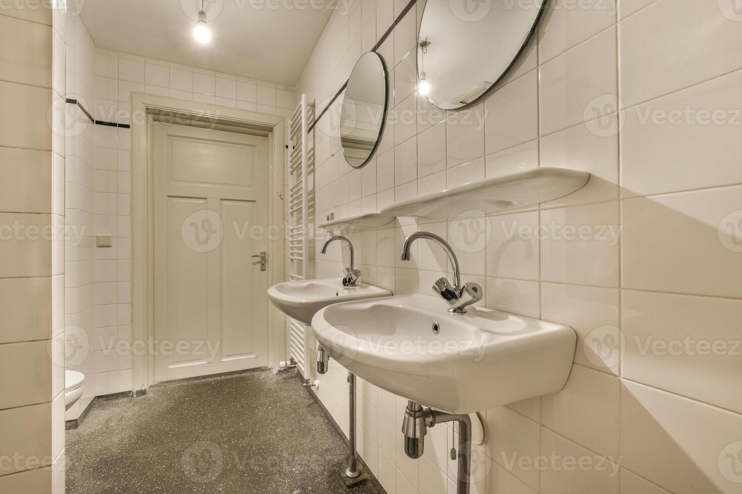 A bathroom with two sinks and a mirror photo