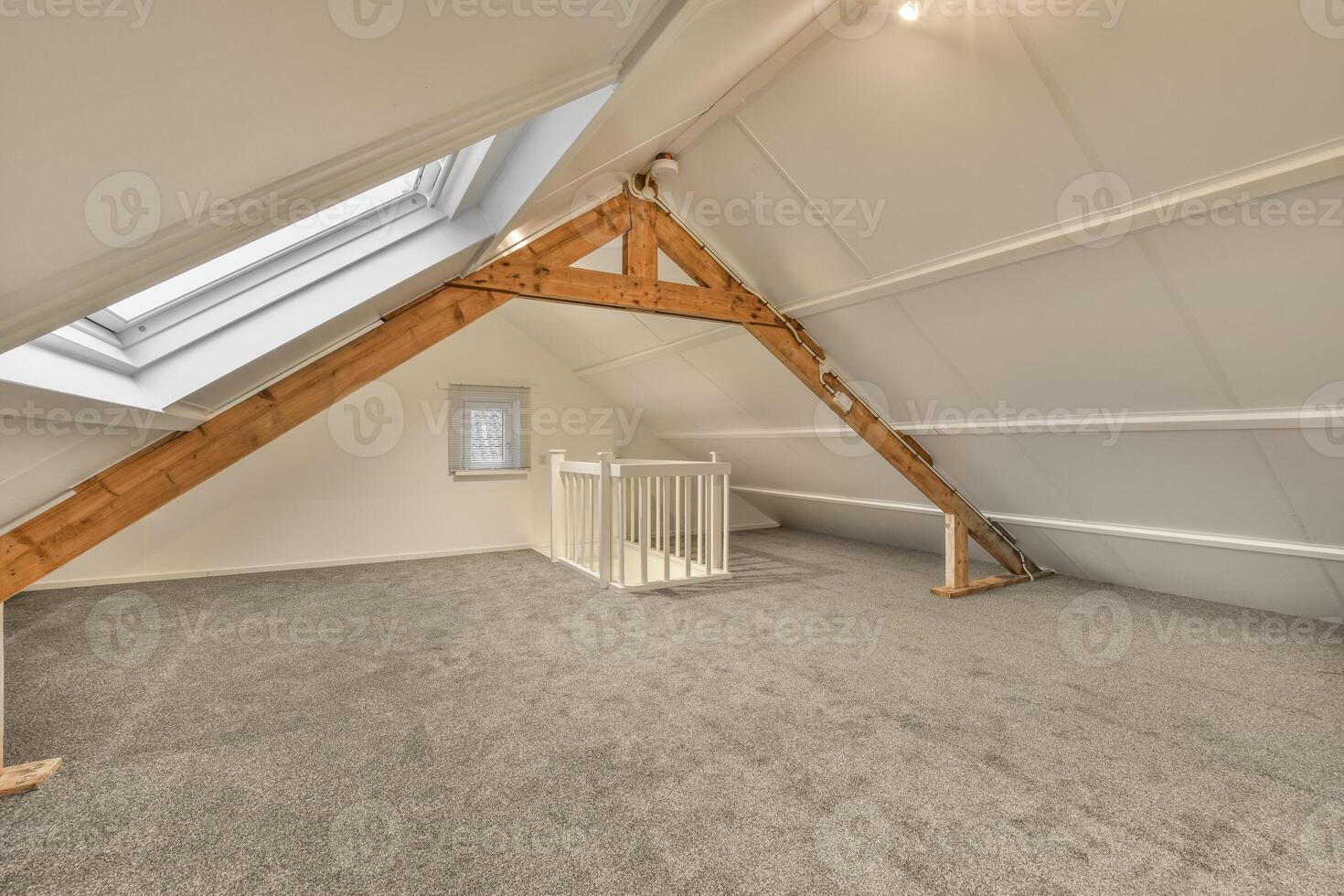 An attic with a wooden beam and a window photo
