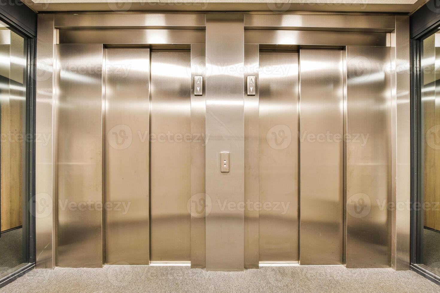 A large elevator with two doors and a glass wall photo