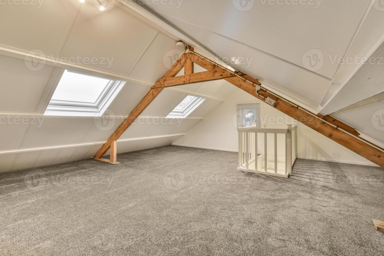 An attic with a wooden beam and a window photo