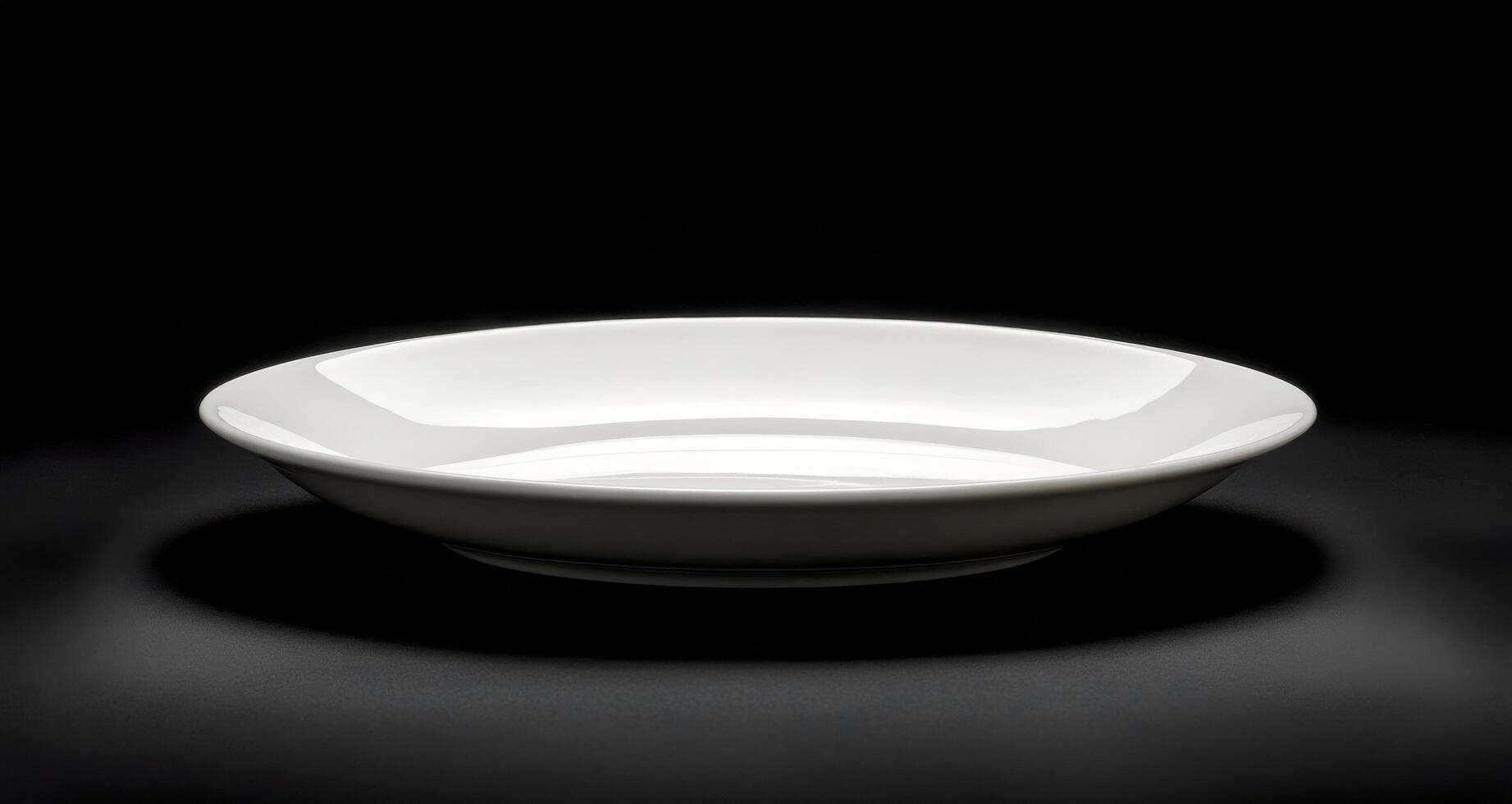 Simple white ceramic plate on a dark background showcasing elegant design and form photo