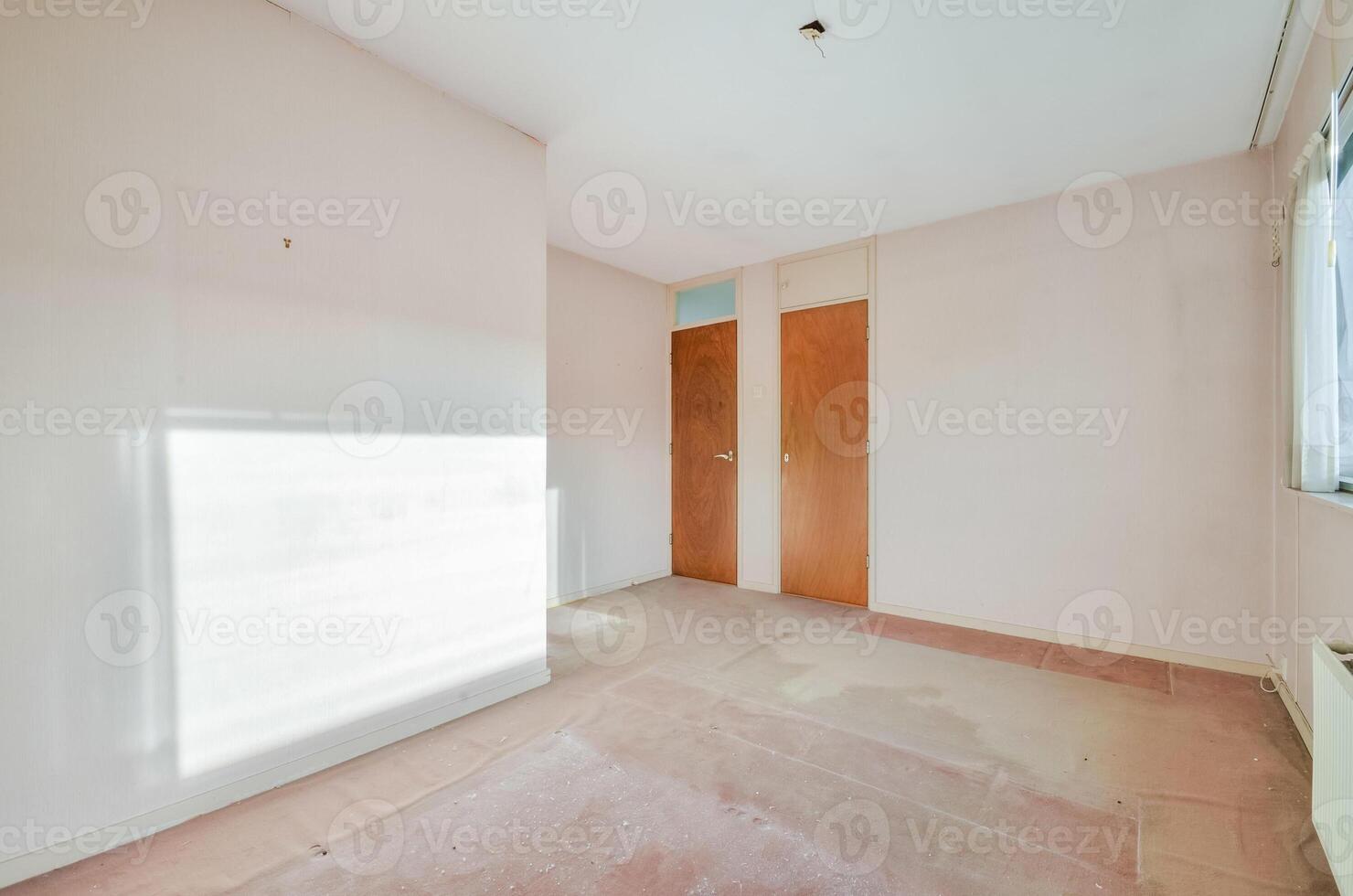 An empty room with a door and a window photo
