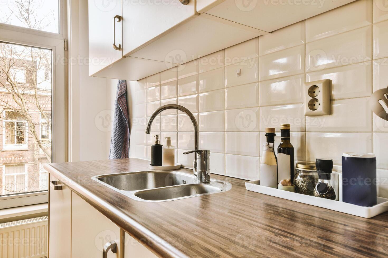 A kitchen with a sink and counter top photo