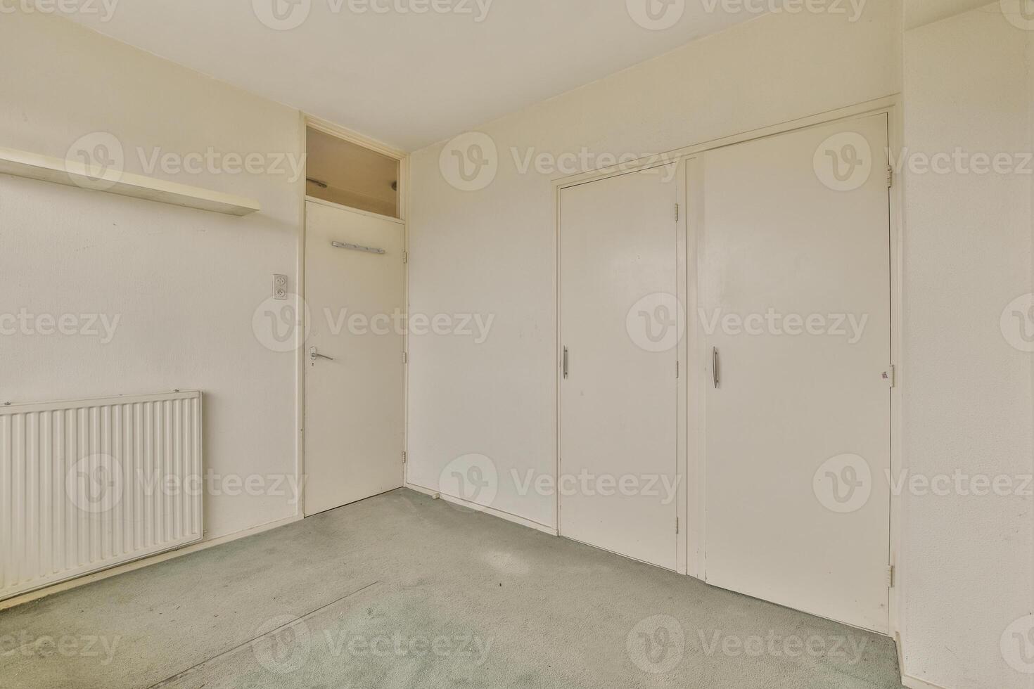 An empty room with a radiator and a door photo