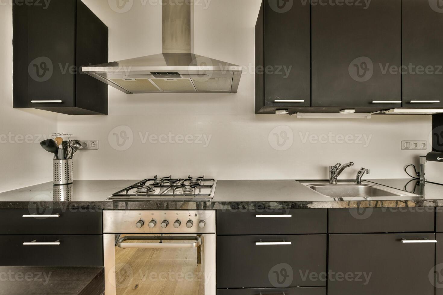 A kitchen with a stove and oven photo