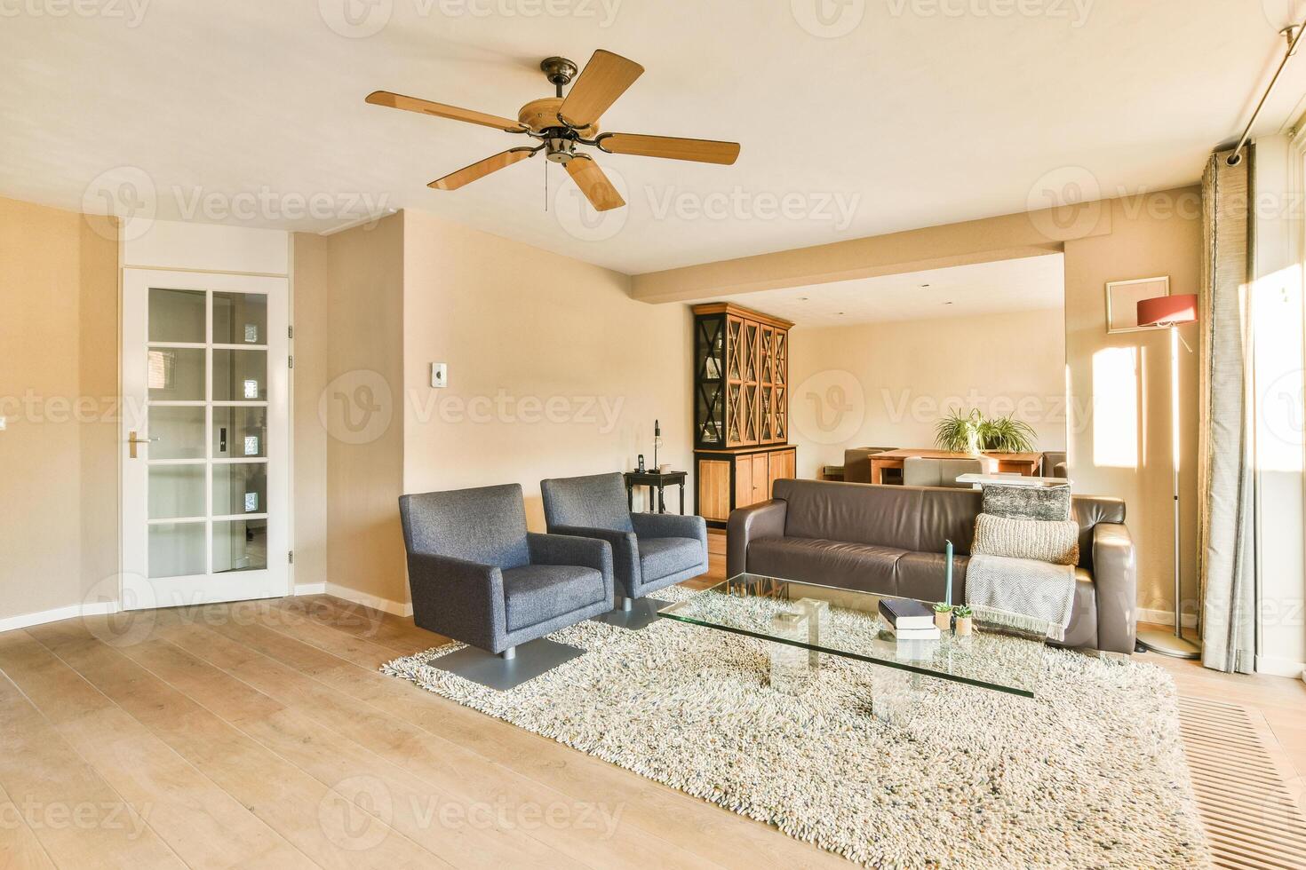 A living room with a couch, a coffee table, a television and a fan photo