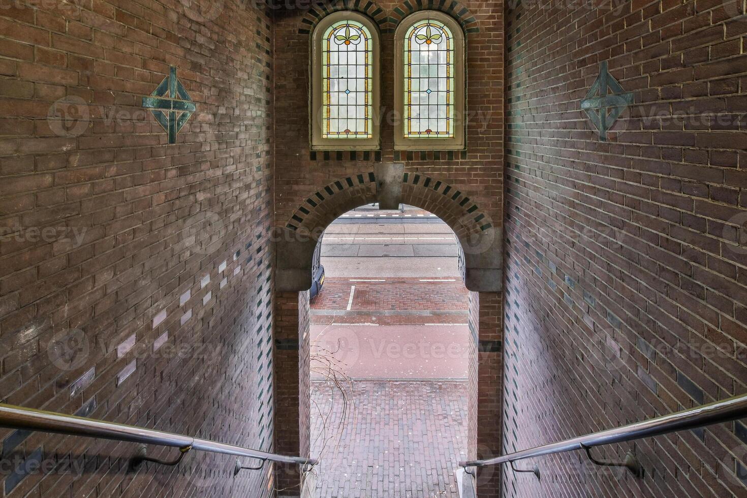 A stairway leading to a brick building with two windows photo