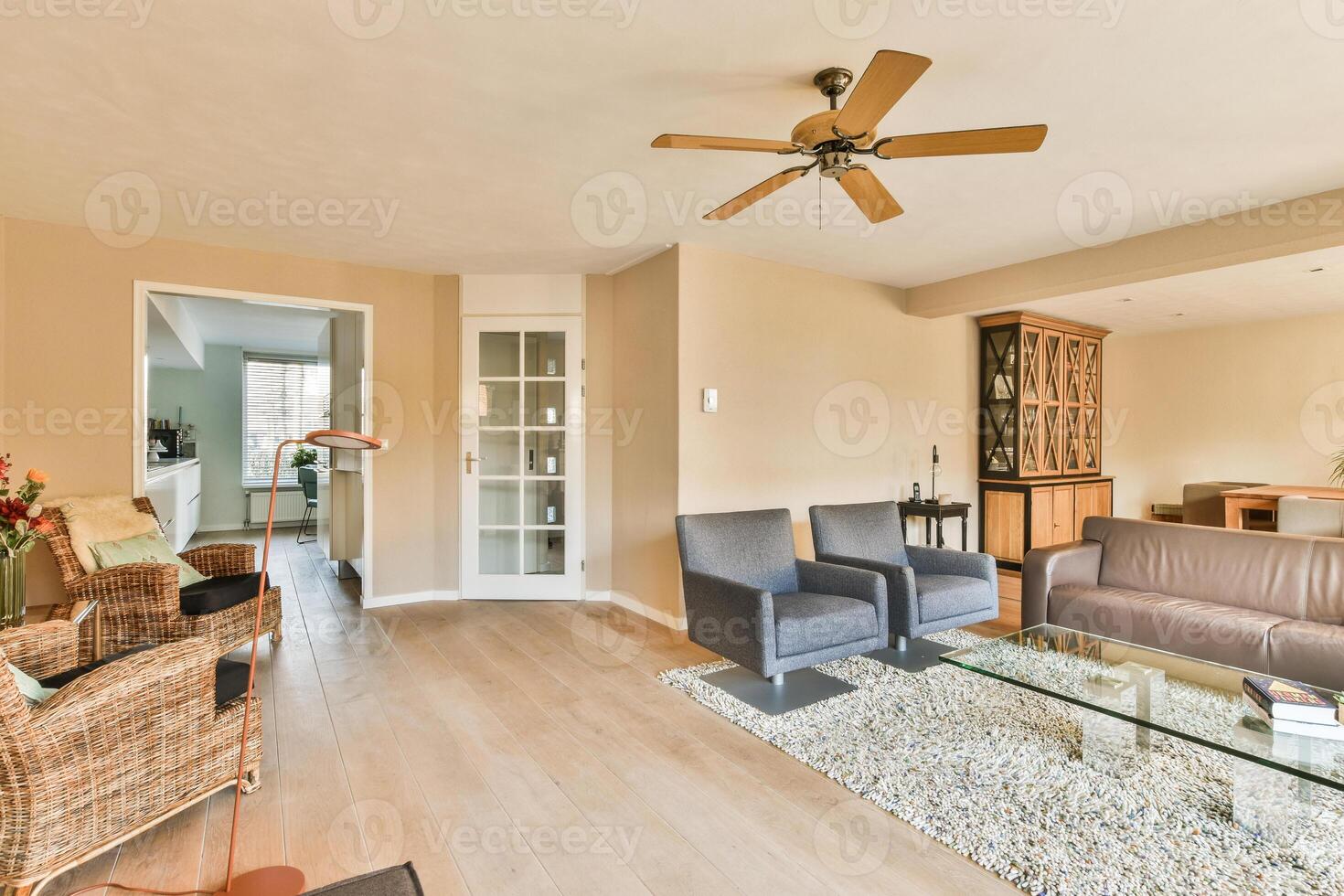 A living room with a couch, coffee table, and a fan photo