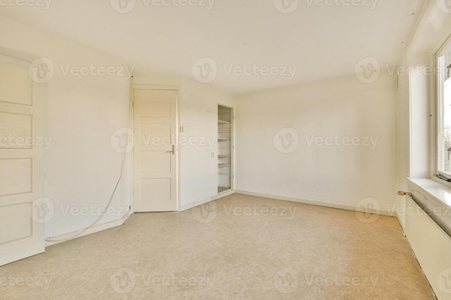 An empty room with a window and a door photo
