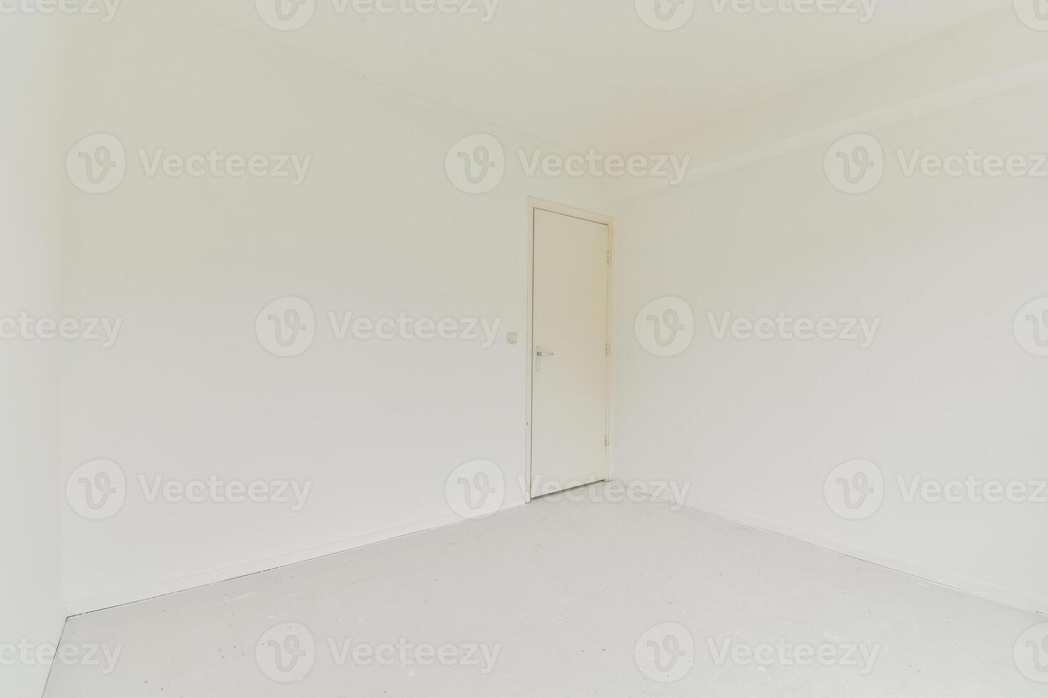 An empty room with white walls and a door photo