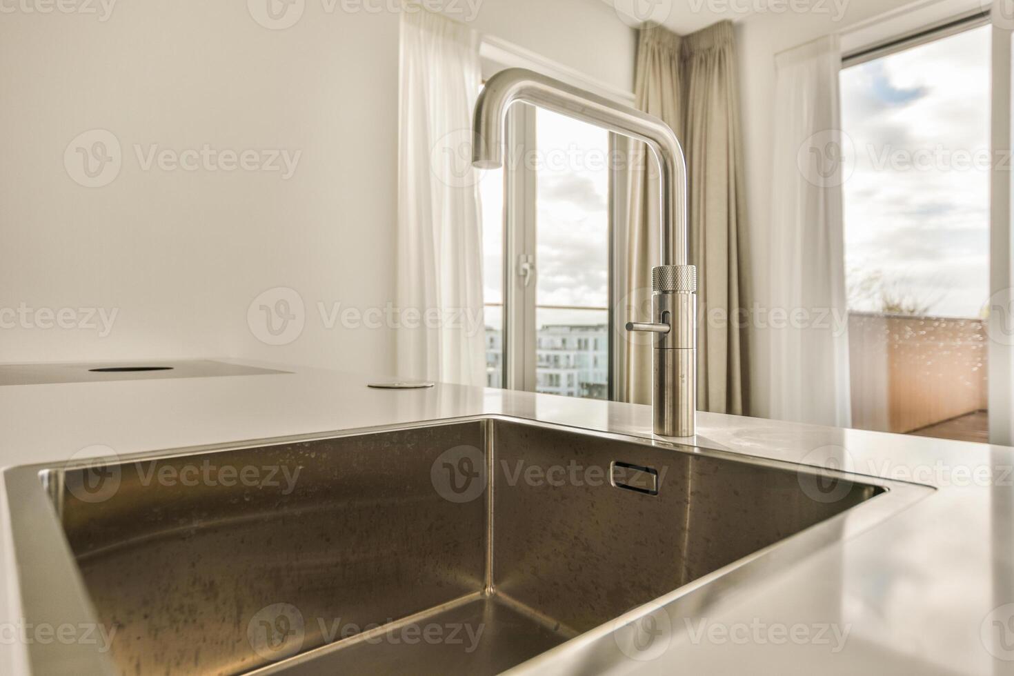A kitchen sink with a faucet photo