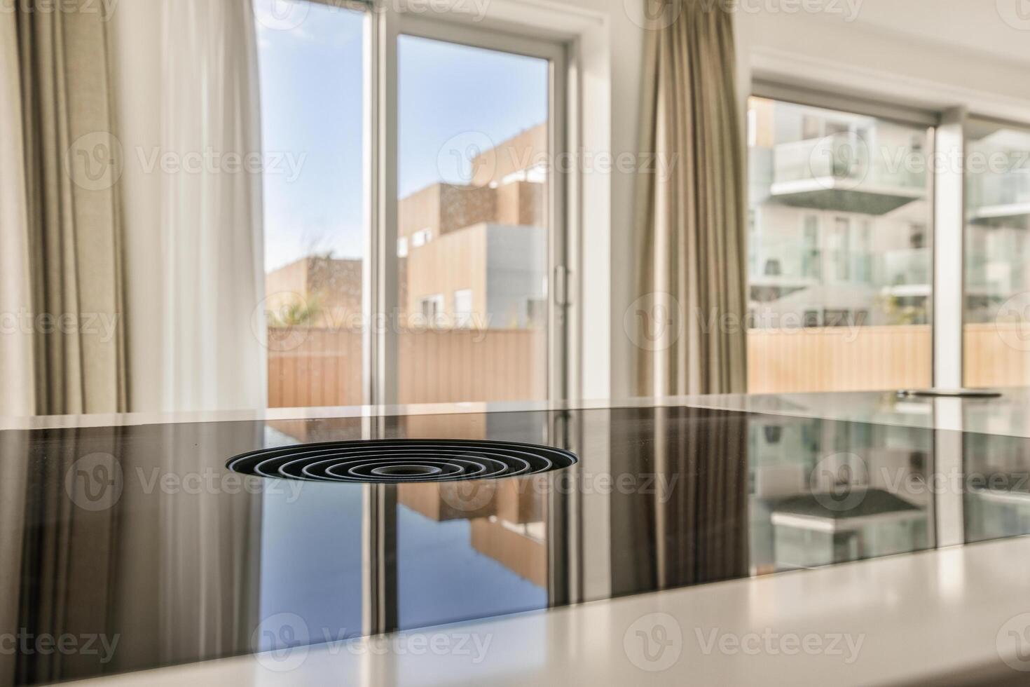 A modern kitchen with a glass top and a window photo