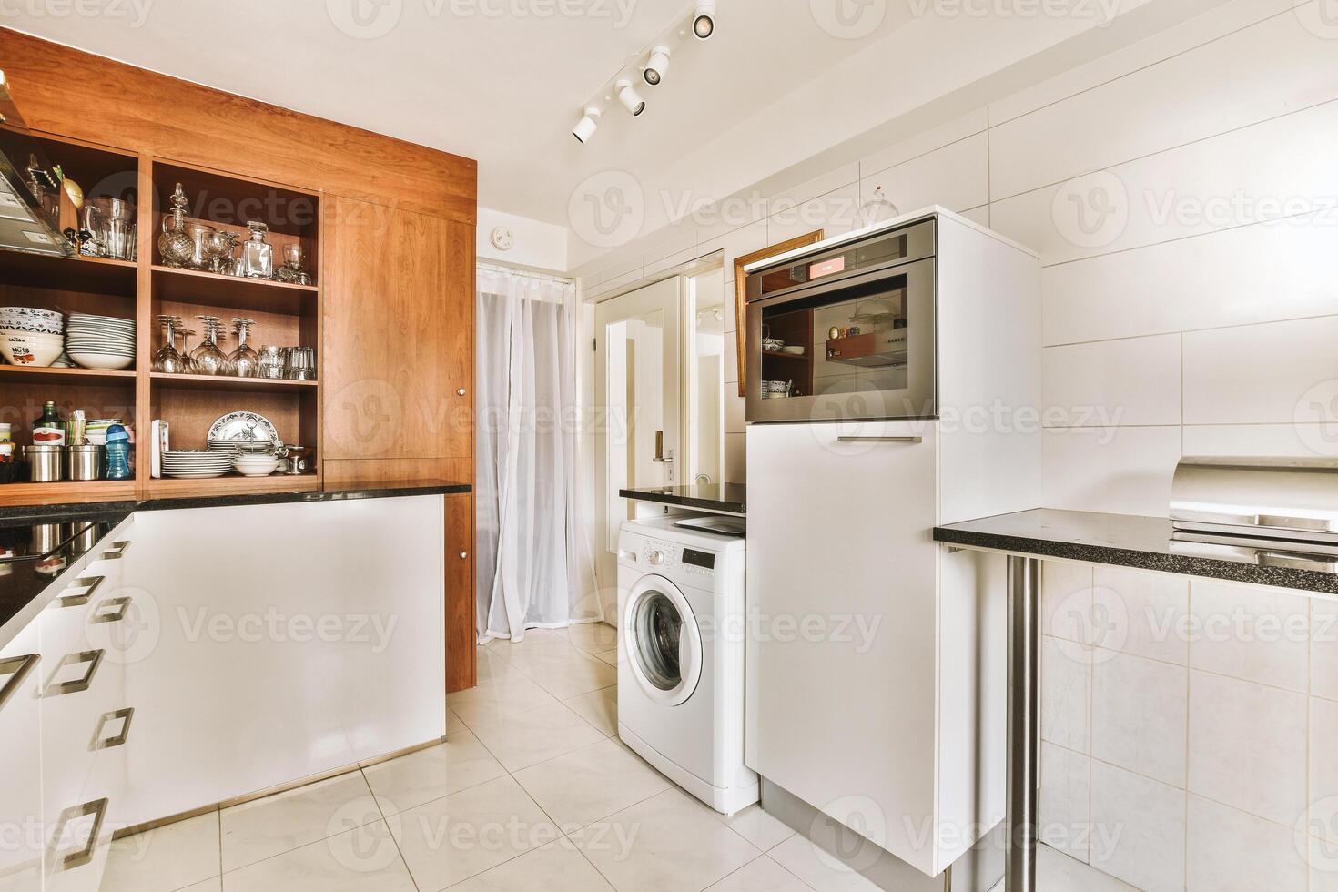 A kitchen with a washer and dryer photo