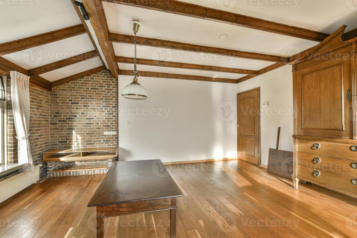A room with wooden floors and exposed beams photo