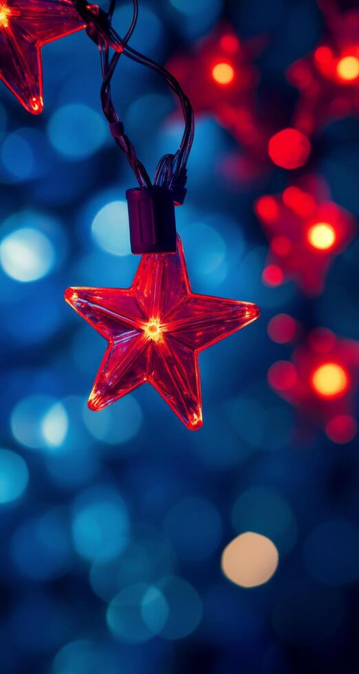 Bright red star ornament glows against a blue and bokeh background during festive season photo