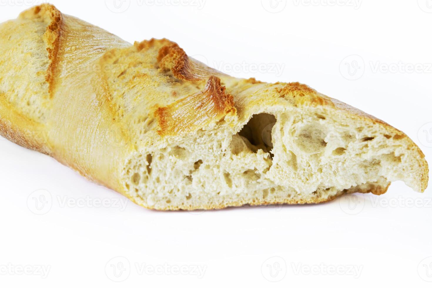 Closeup of a sliced French baguette with a crispy crust and airy texture isolated on a white background. With clipping path. Copy space photo