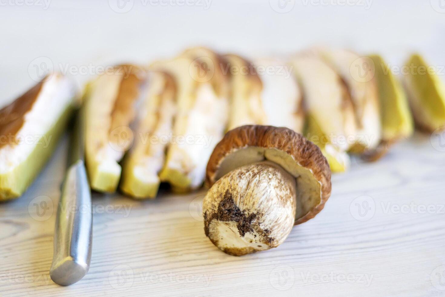 Close up of freshly sliced wild boletus mushrooms ready for cooking. Cutting, slicing freshly picked white fungus for gourmet recipes and healthy meals. Copy space. Selective focus. photo