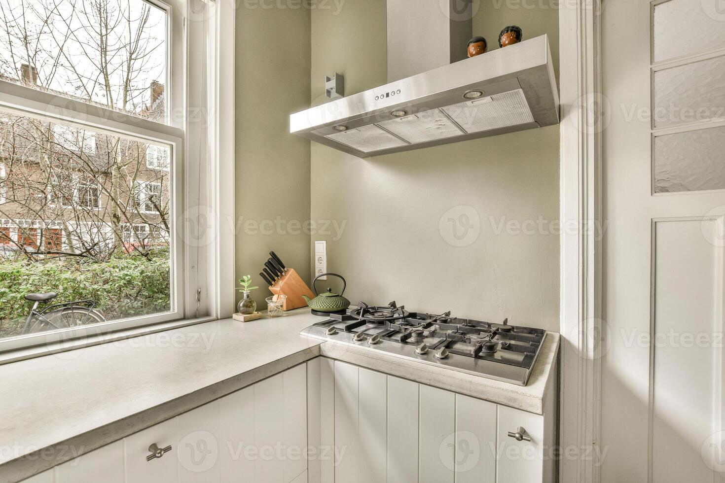 A kitchen with a stove and a window photo