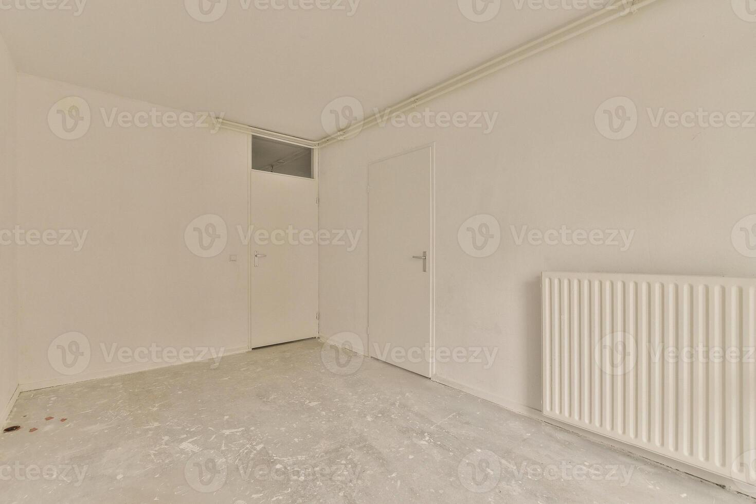 An empty room with a radiator and a door photo