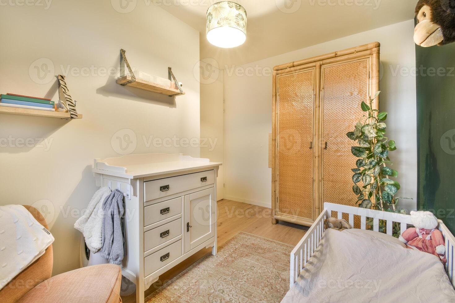 A small room with a bed, dresser and a cabinet photo