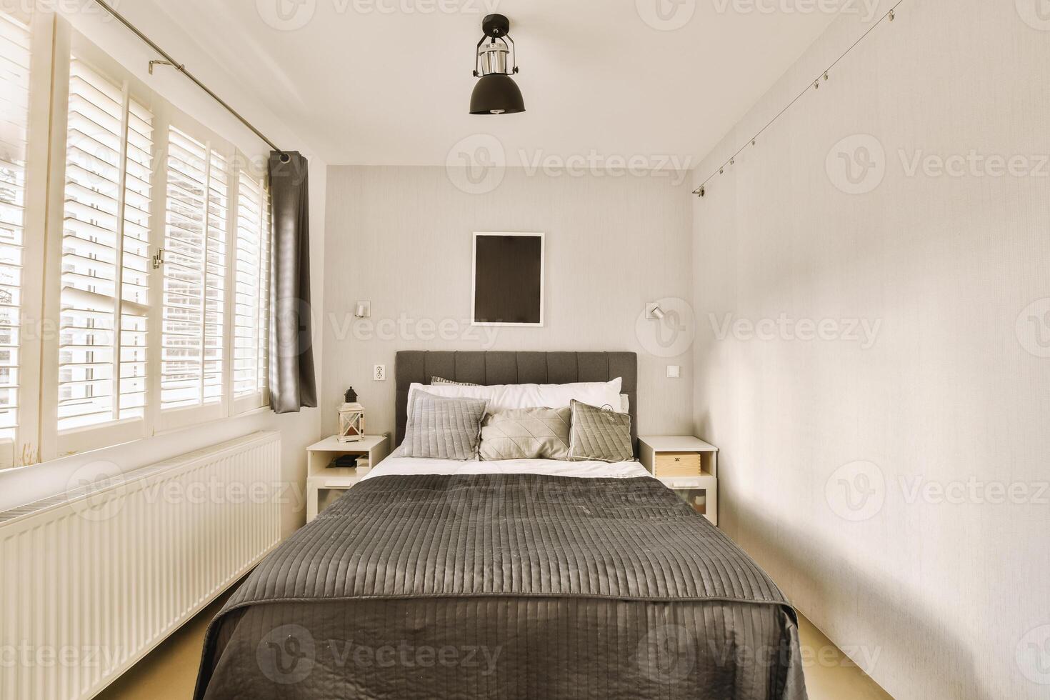 A small bedroom with a bed and a window photo