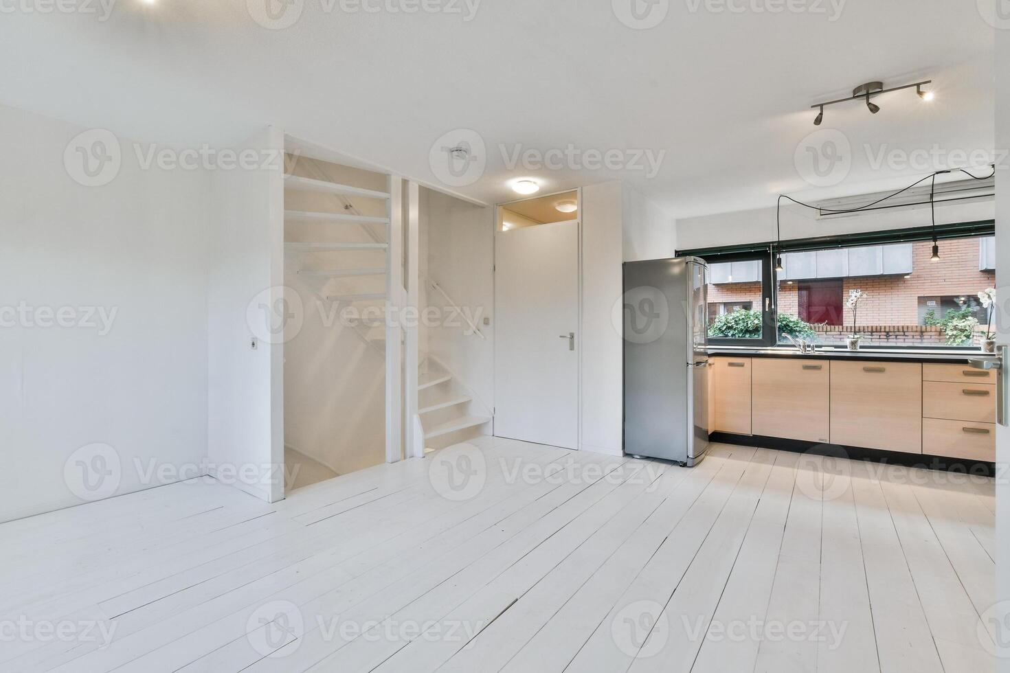 A kitchen with white floors and wooden cabinets photo