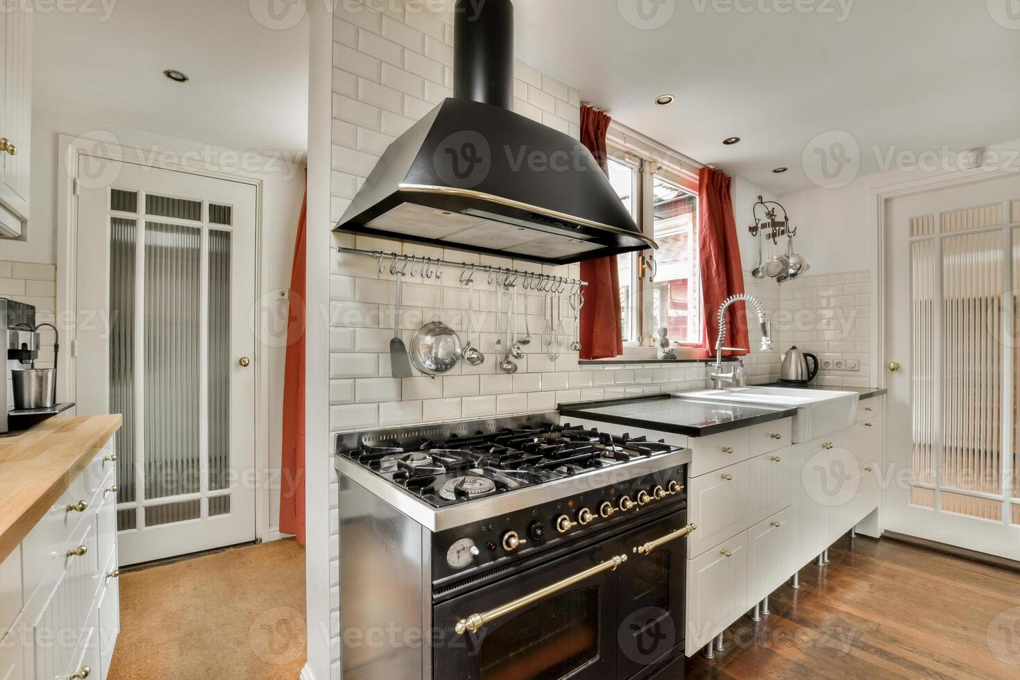 A kitchen with a stove, oven, sink and refrigerator photo